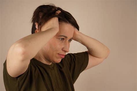 The Surprised Brunette Grabbed Her Head She Looks Away And Thinks Close Up Stock Image