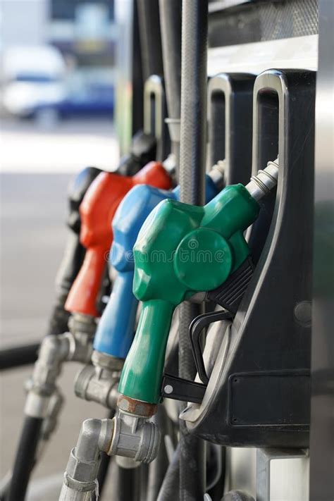 Petrol Pump Filling Nozzles Fuel At Gas Station Close Up Stock Photo