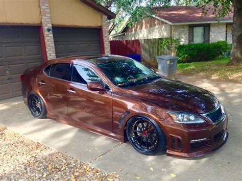 A Brown Car Parked In Front Of A House