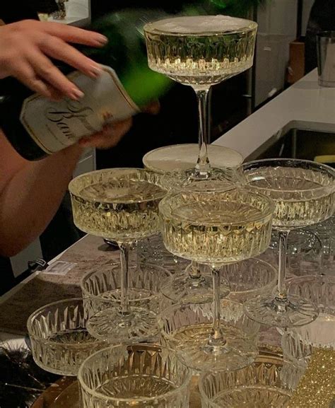 Several Wine Glasses Stacked On Top Of Each Other With Champagne Being