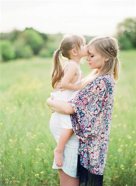 Pregnant Mother Holding Her Young Daughter By Stocksy Contributor