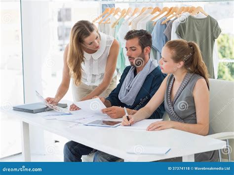 Three Fashion Designers Discussing Designs Stock Photo Image Of