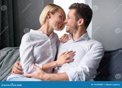 Caressing Couple In Love Sitting On Couch Stock Image Image Of