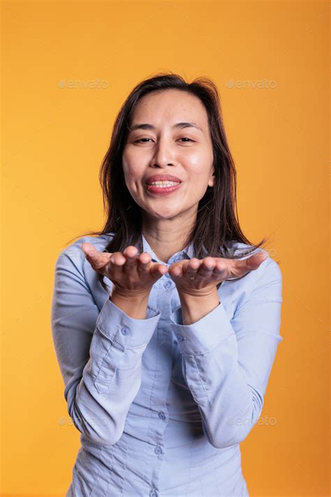 Cheerful Brunette Filipino Woman Blowing Air Kissed Stock Photo By DC