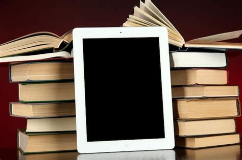 Premium Photo Tablet And Books On Bright Background