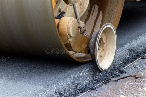 Asphalt Paver On The Road During Asphalt Compaction Close Up Road