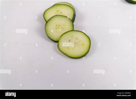 Group Of Fresh Cucumber Slices Isolated On A White Surface Stock Photo