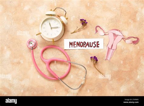 Word Menopause With Flowers Stethoscope Clock And Paper Uterus On
