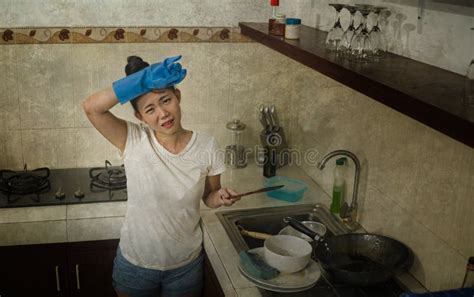 Young Beautiful Frustrated And Upset Asian Woman In Domestic Chores