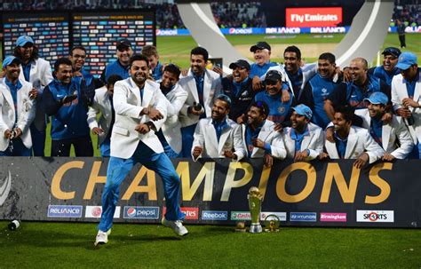 The Victorious Indian Team Pose Behind The Champions Trophy Banner