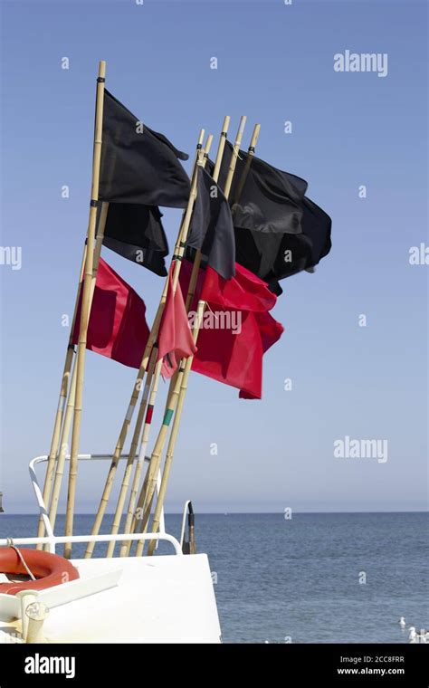 Red and black flags on the boat on the sea in Denmark Stock Photo - Alamy