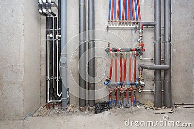 Pipes Of Heating And Water Supply System On The Background Of A