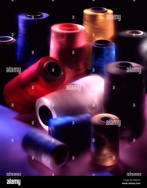 Large Spools Of Colorful Thread In Strong Revealing Light Stock Photo