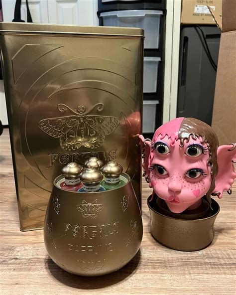 A Pink And Brown Ceramic Head Next To A Metal Container