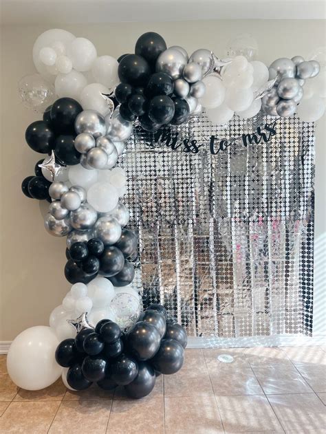 Black And White Balloons Are Arranged In The Shape Of An Arch