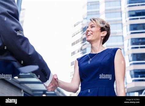 Businesswoman Standing And Talking To Her Colleague Outdoors Stock