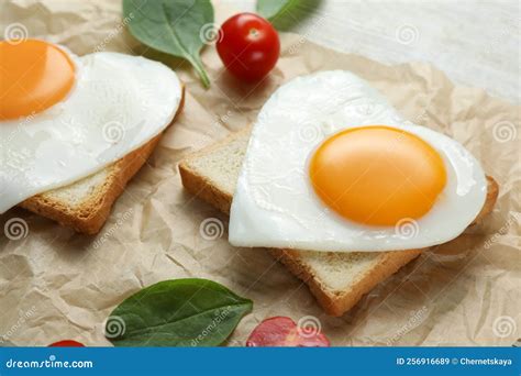 Heart Shaped Fried Eggs With Toasts Spinach And Tomatoes On White