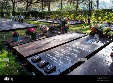 Peaceful Cemetery Scene With Ground Level Niches Adorned With Vibrant