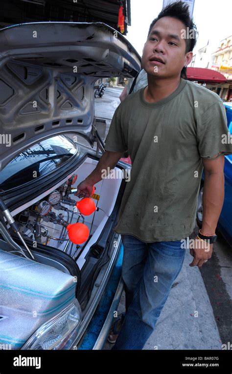 thai man with checking circuit of his decorated hydraulic dance car ...