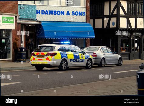 A Police Vehicle Stopping A Car In The Marketplace During Coronavirus