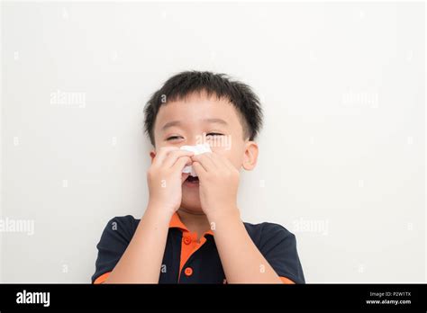 Cute Little Boy Sneezing In Tissue On White Background Stock Photo Alamy