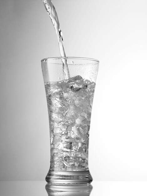 Premium Photo Water Being Poured In Glass Against White Background