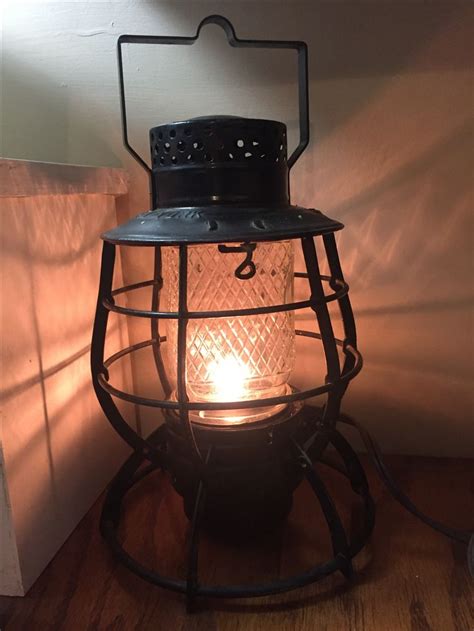 a light that is sitting on top of a wooden table next to a wall and floor