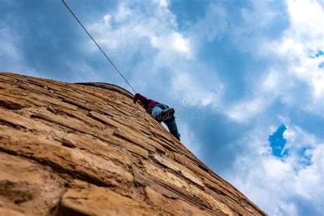 A Man Climbs Up A Tower With A Rope Stock Photo Image Of Climbing