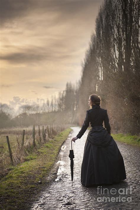 Victorian Woman Walking On A Cobbled Avenue At Sunset Photograph By Lee