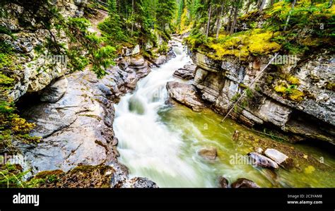 The Turbulent Waters Of The Maligne Canyon Flowing Through The Deep