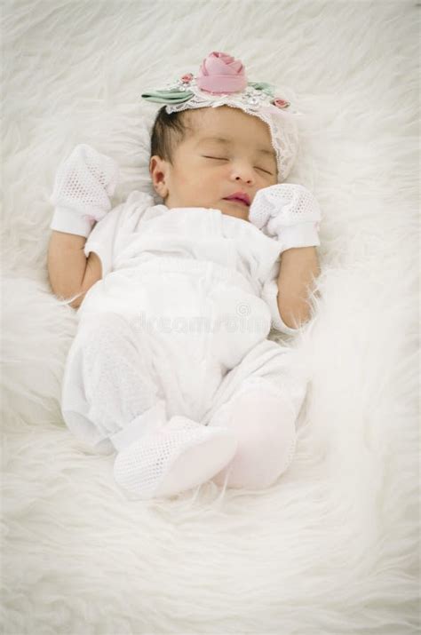 Portrait Of Cute Newborn Baby Sleeping On White Blanket Stock Photo