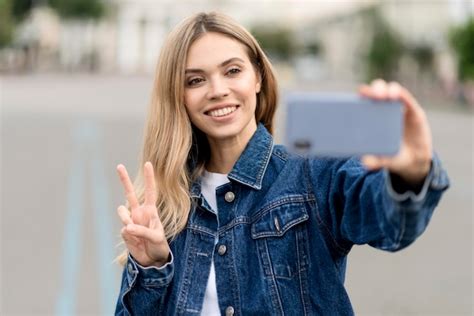 Free Photo Cute Blonde Girl Taking A Selfie Peace Sign