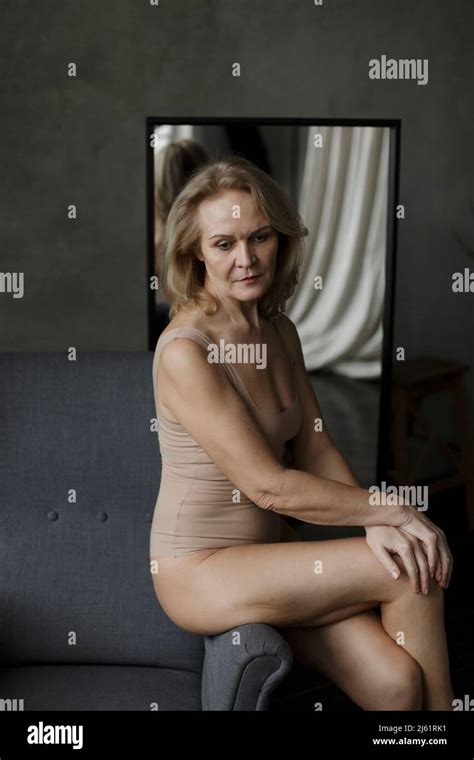 Pensive Mature Woman Sitting Couch Home Hi Res Stock Photography And
