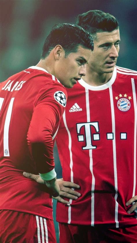 Two Soccer Players Standing Next To Each Other In Front Of The Camera