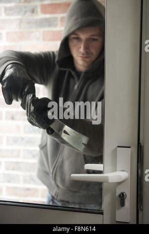 Burglar Using Crowbar To Break Into A House At Night Stock Photo Alamy