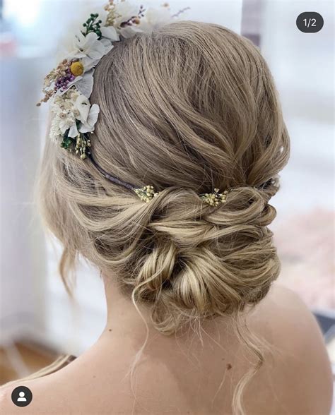 The Back Of A Woman S Head With Flowers In Her Hair And Braid