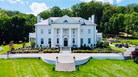 An Aerial View Of A Large White House With Steps Leading Up To The