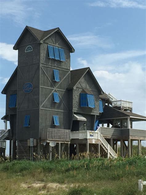 an old house with blue shutters on the front and second story is ...