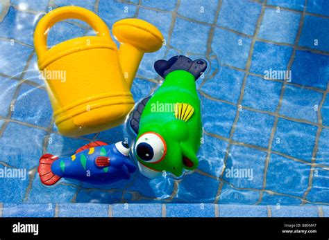 Plastic toys in swimming pool Stock Photo - Alamy