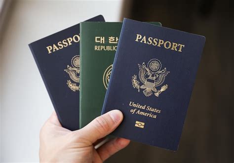 Premium Photo A Person Holding Two Passports With The Word Passport