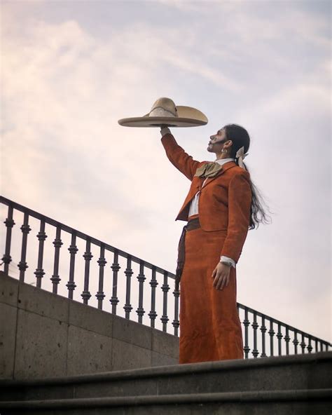 Catrina in Traditional Clothing Holding Sombrero in Raised Arm · Free ...