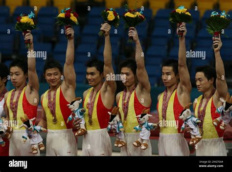 Chinese Men S Gymnastic Team Celebrates On The Podium After Winning The Gold Medal In The Asian