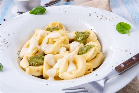 A Tortellini Di Formaggio With Basil Pesto And Cheese Sauce Stock Image