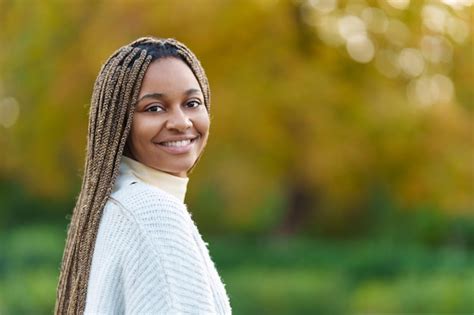 Premium Photo African Woman Turning To Smile At The Camera