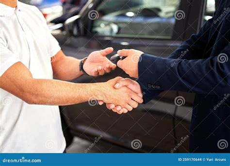 Congratulations On Your New Ride A Car Salesman Handing Over Keys And