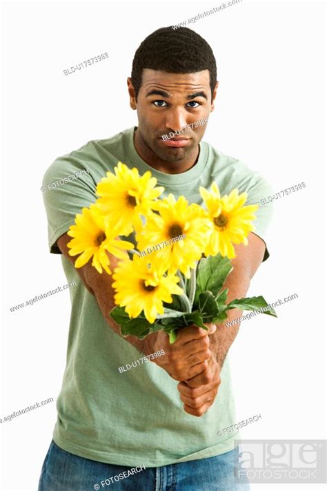 Pouting male holding out bouquet of yellow flowers to unseen person, Stock Photo, Picture And ...