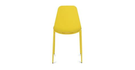 A Yellow Plastic Chair Sitting On Top Of A White Floor Next To A Metal