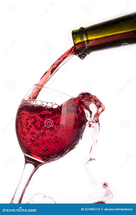 Red Wine Pouring Into The Glass From Bottle Isolated On White