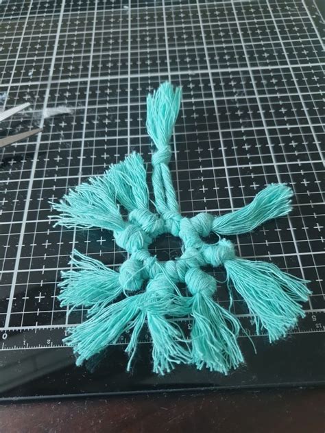 There Is A Piece Of Yarn That Has Been Made Into A Snowflake Ornament