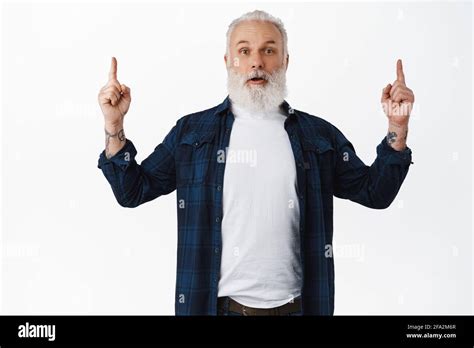 Surprised Mature Man Gasping Amazed Pointing Fingers Up And Showing